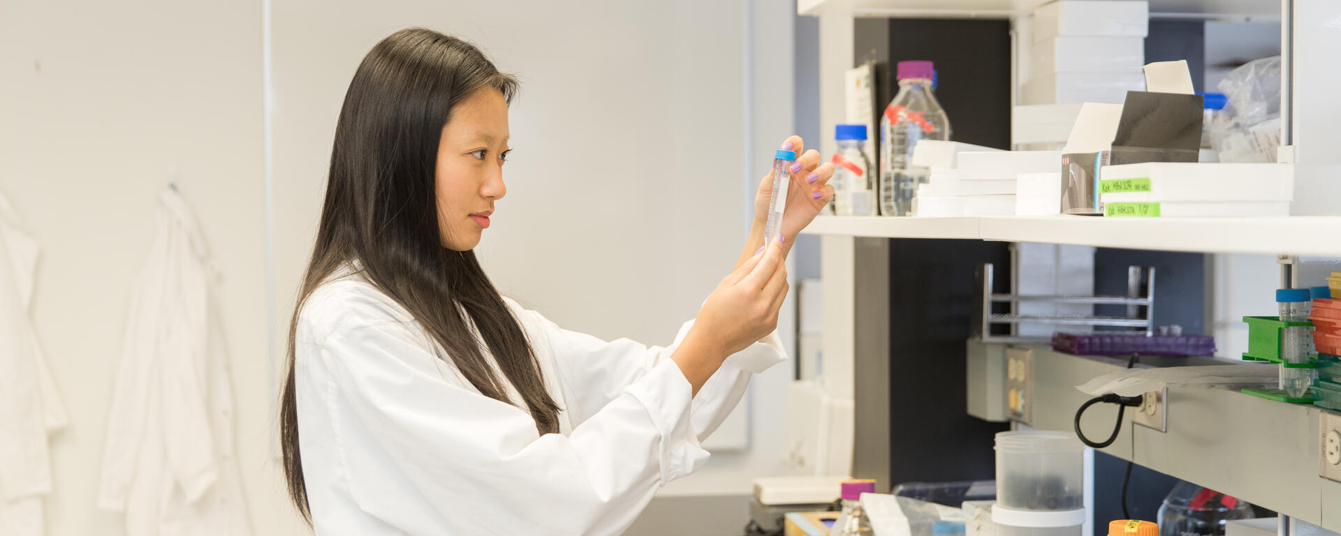 a student looking at test tubes